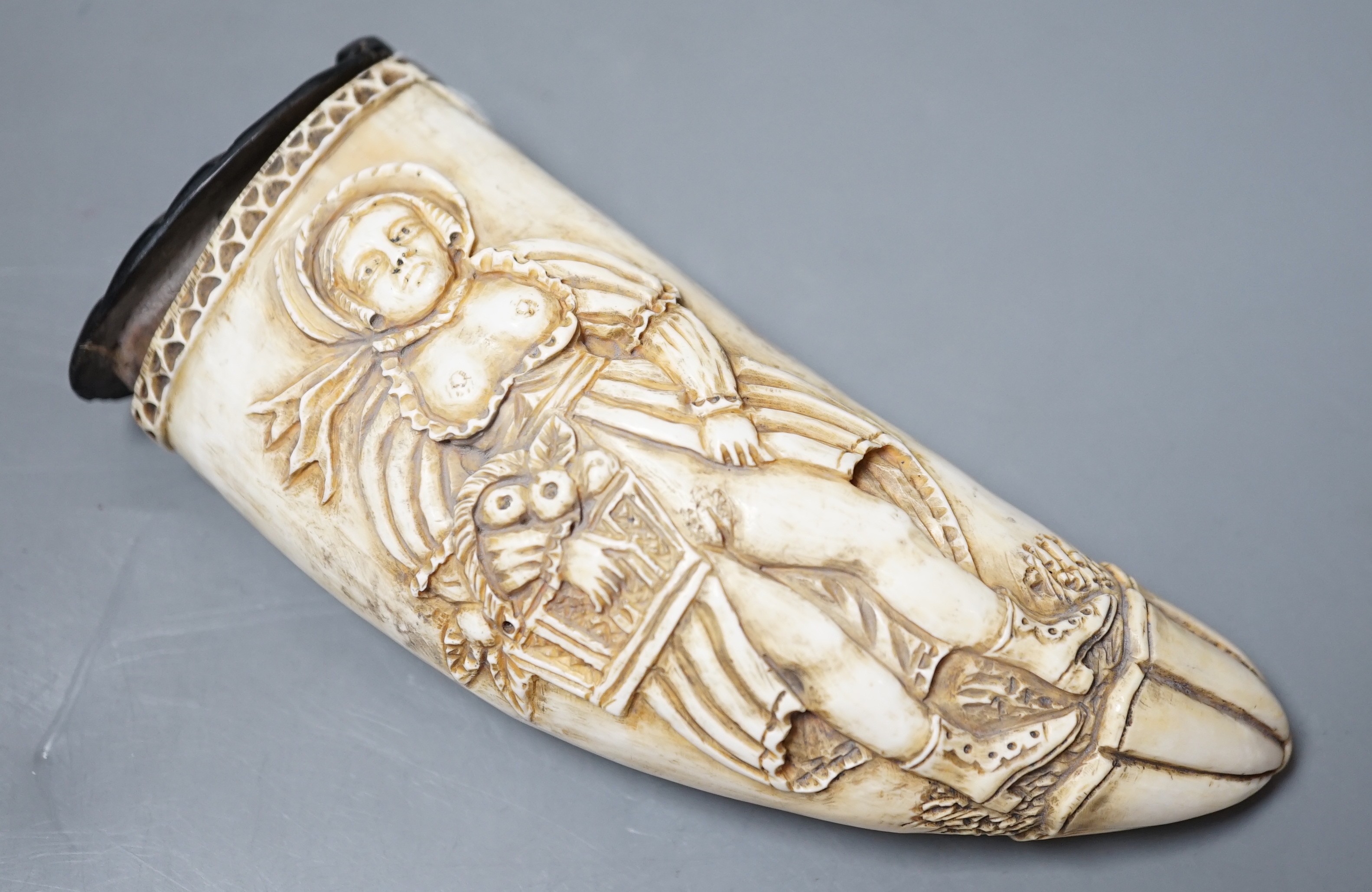 A worked scrimshaw depicting an erotic female fruit seller, dated 1862 to reverse, with a shell carved baleen hinged lid. 13cm long